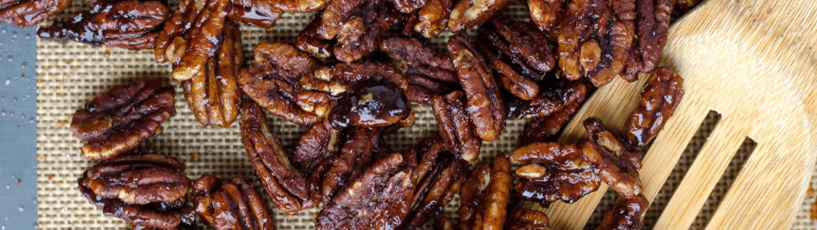 Pecans on Table with Wooden Spoon