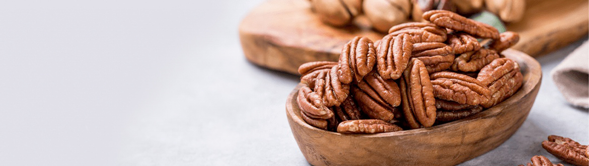 Pecans Overflowing From a Wooden Bowl