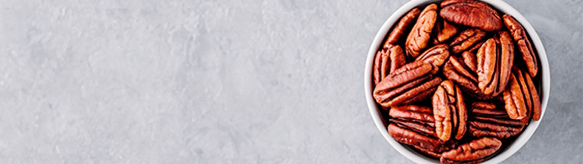 Full Cup of Pecans On White Table