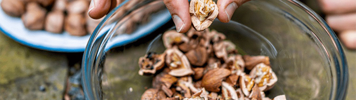 Broken Pecans in a Glass Bowl