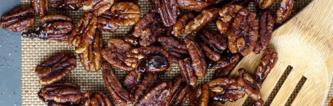 Pecans on Table with Wooden Spoon
