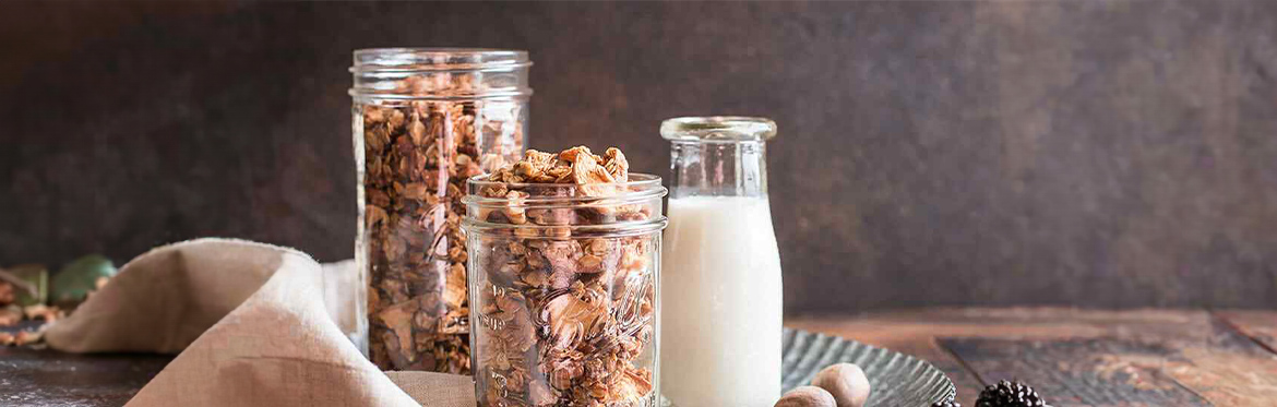 Homemade Pecan Granola in Jars with Glass of Milk
