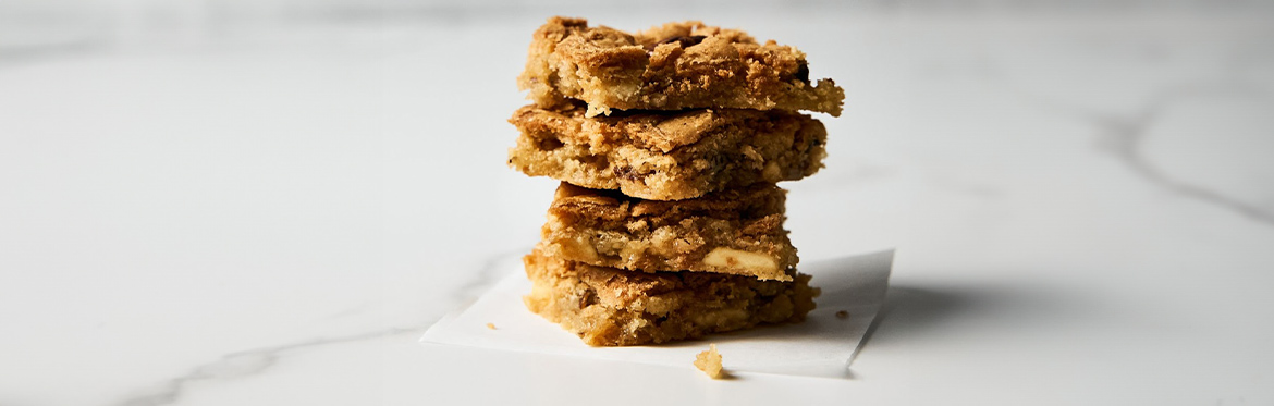 Four Maple Pecan Blondies Stacked on Each Other